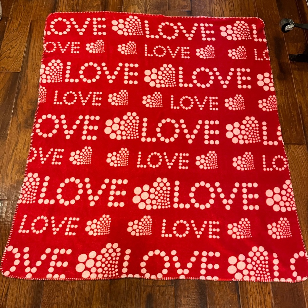 Red Fleece Blanket with White LOVE & Heart Patterns. Measures 56”x47”
